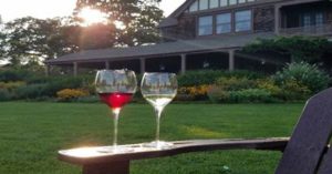 Image of two wine glasses on an adirondack chair on the Great Lawn